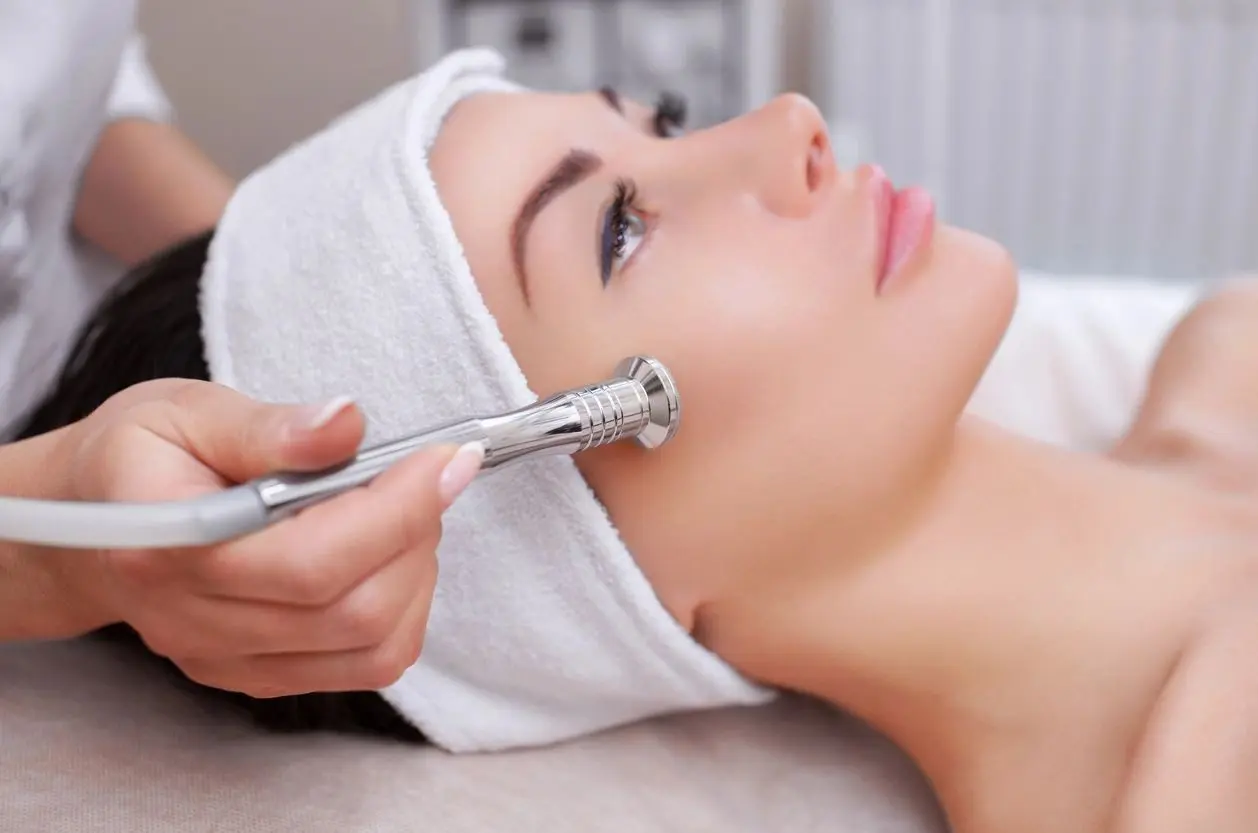 A woman getting her face waxed at the spa