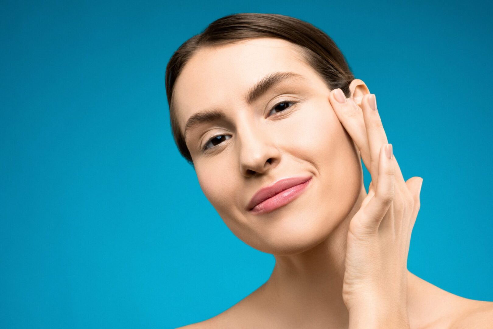 A woman with her hand on the side of her face.